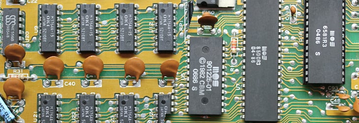 Commodore 64 Motherboard showing MOS 6502 processor, PLA chip, and RAM chips