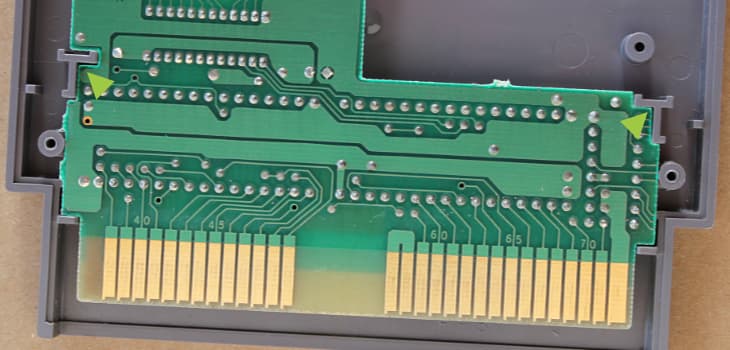 The NES game board should fit in the shell by matching the plastic guides