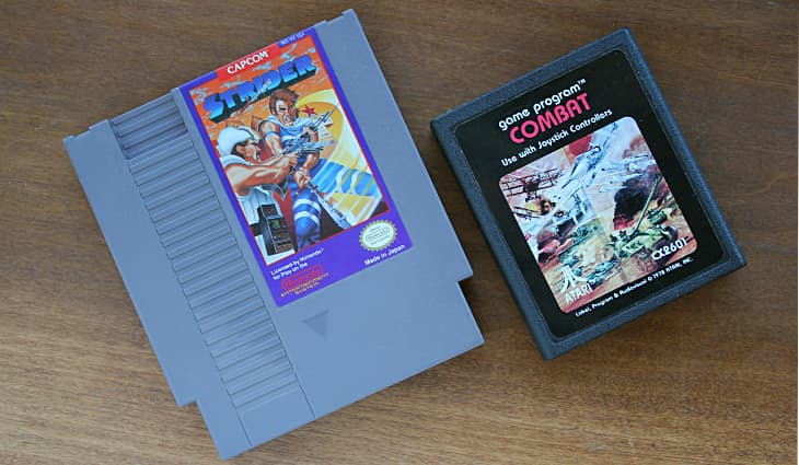 NES Cartridge - Strider next to Atari Cartridge - Combat NES Cartridge - Strider next to Atari Cartridge - Combat